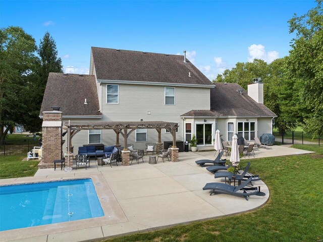 rear view of property featuring a pergola, a lawn, a patio area, and a fenced in pool