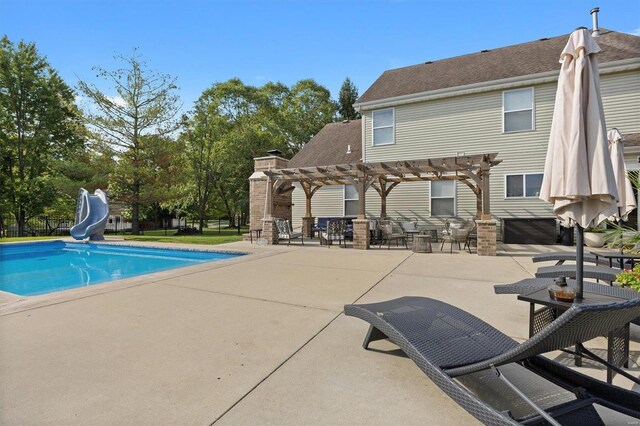 view of swimming pool with a pergola, a patio area, and a water slide