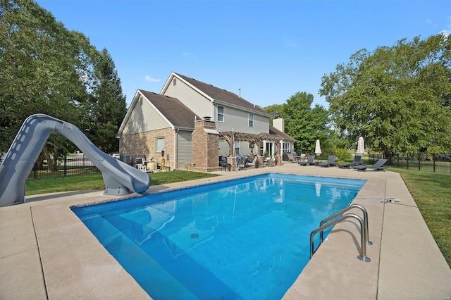 view of pool featuring a water slide and a patio area