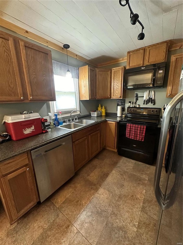 kitchen with pendant lighting, sink, and black appliances