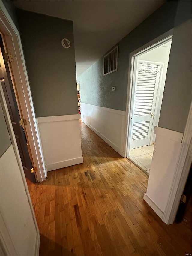 corridor with wood-type flooring