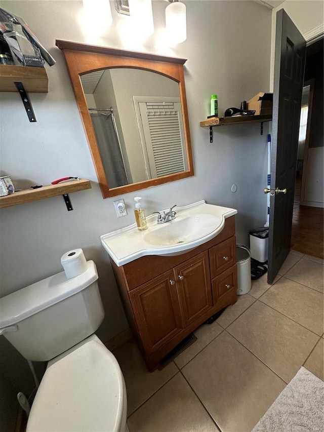 bathroom with vanity, tile patterned floors, and toilet