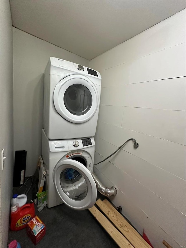 laundry room with stacked washer and dryer