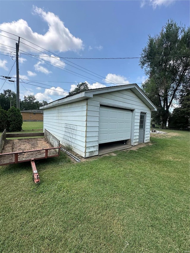 garage featuring a yard