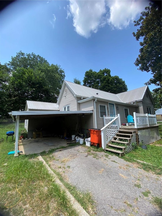 view of side of property featuring a carport and a deck