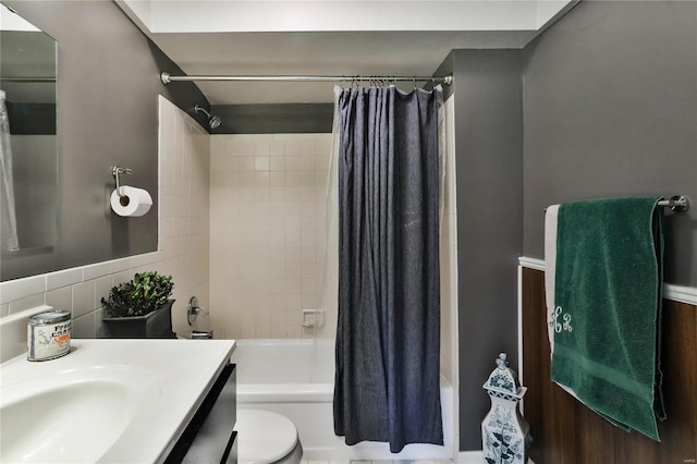 full bathroom with vanity, shower / tub combo with curtain, and toilet