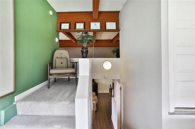 stairs with beam ceiling and hardwood / wood-style floors