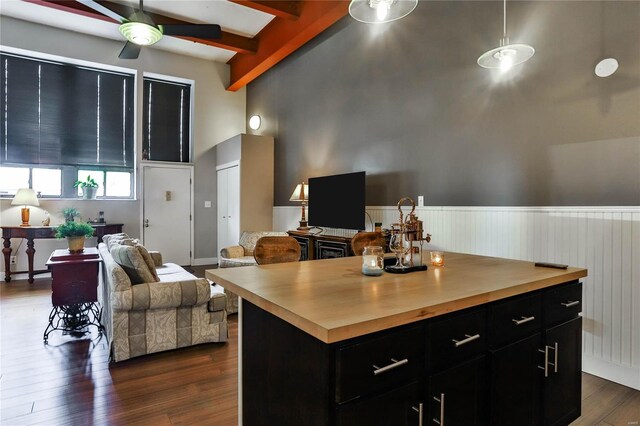 kitchen featuring wood counters, a center island, ceiling fan, and dark hardwood / wood-style floors