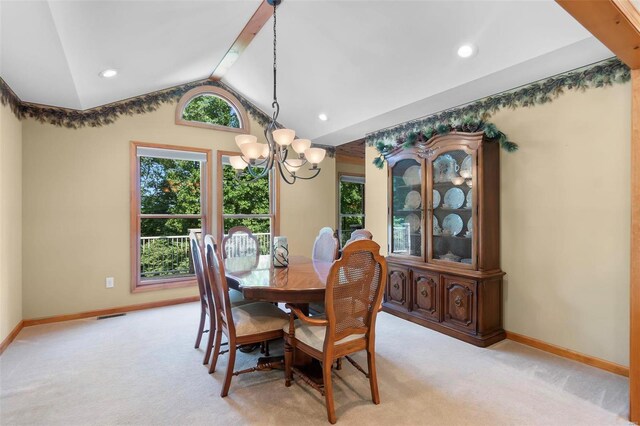 dining area featuring vaulted ceiling with beams, a chandelier, and light colored carpet