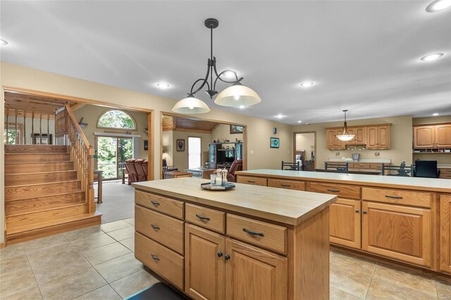 kitchen featuring a center island, hanging light fixtures, and light tile patterned floors