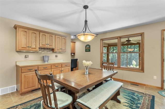 dining space featuring light tile patterned floors and ceiling fan