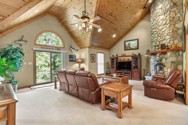 living room featuring a stone fireplace, a wealth of natural light, light colored carpet, and high vaulted ceiling