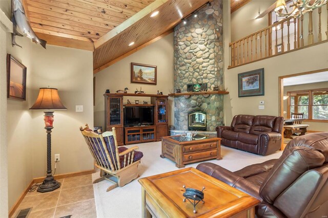 living room featuring wood ceiling, high vaulted ceiling, a fireplace, and light tile patterned floors