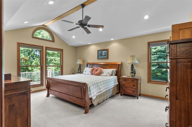 carpeted bedroom with ceiling fan and vaulted ceiling with beams