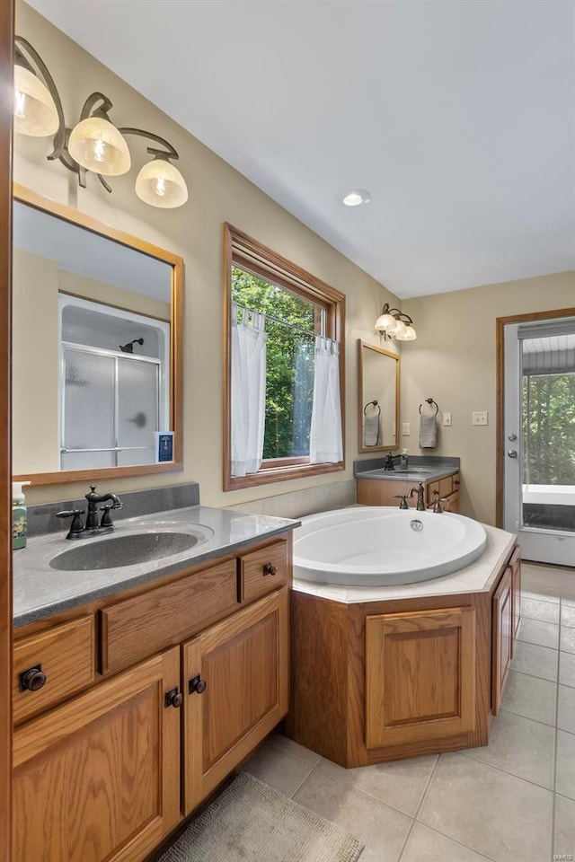 full bathroom featuring tile patterned flooring, a wealth of natural light, and vanity