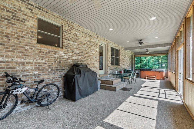 view of patio featuring a ceiling fan, a grill, and a hot tub