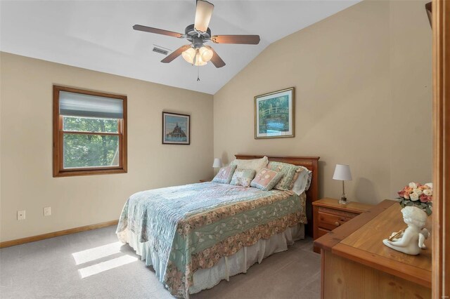 bedroom featuring light carpet, lofted ceiling, and ceiling fan