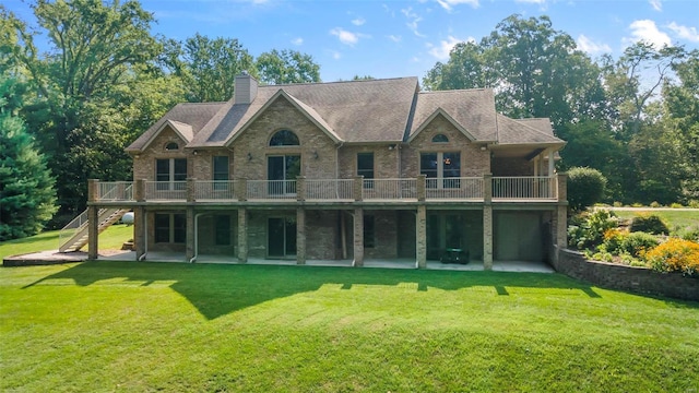 back of house with brick siding, a chimney, a lawn, a wooden deck, and stairs