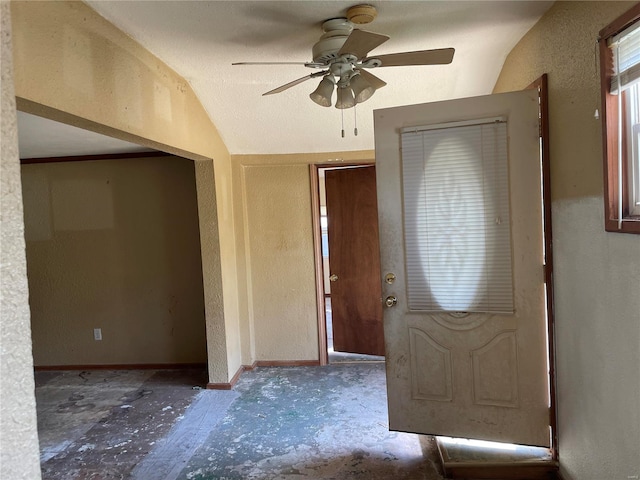 entryway featuring ceiling fan and vaulted ceiling