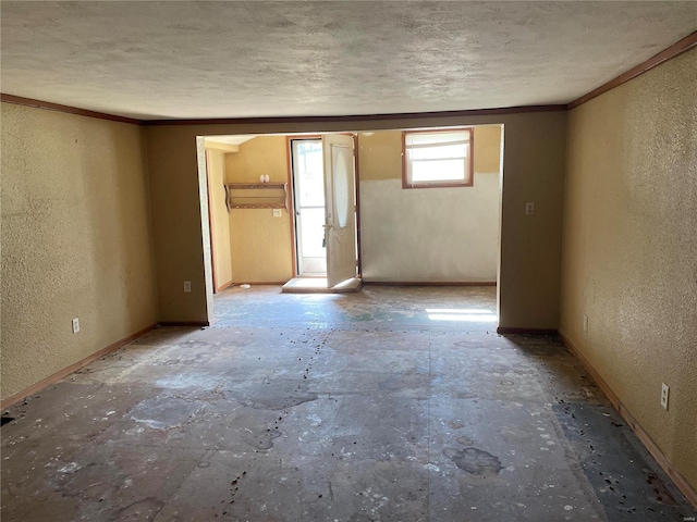 empty room featuring crown molding