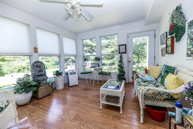 sunroom / solarium featuring plenty of natural light and ceiling fan