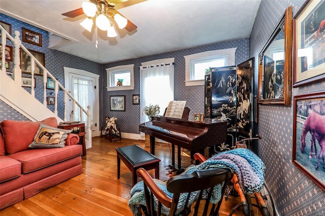 living room with light hardwood / wood-style flooring and ceiling fan