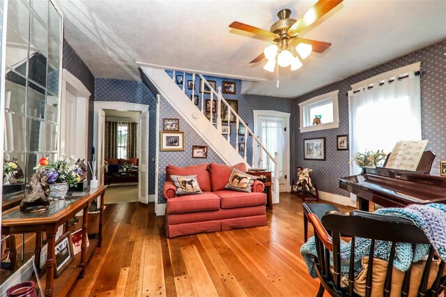 living room featuring hardwood / wood-style flooring and ceiling fan