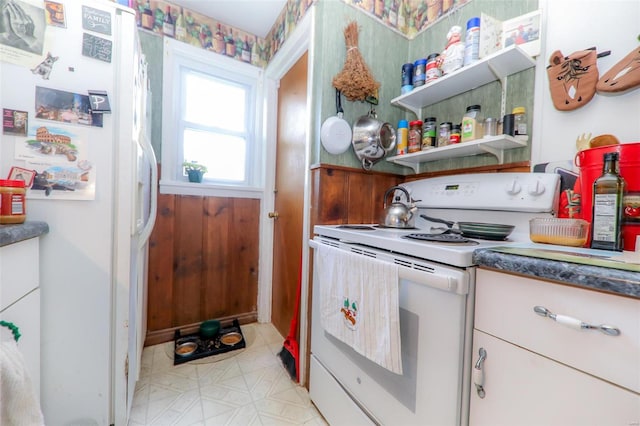 kitchen with white appliances and light tile patterned floors