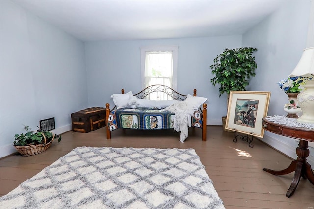 bedroom with hardwood / wood-style floors