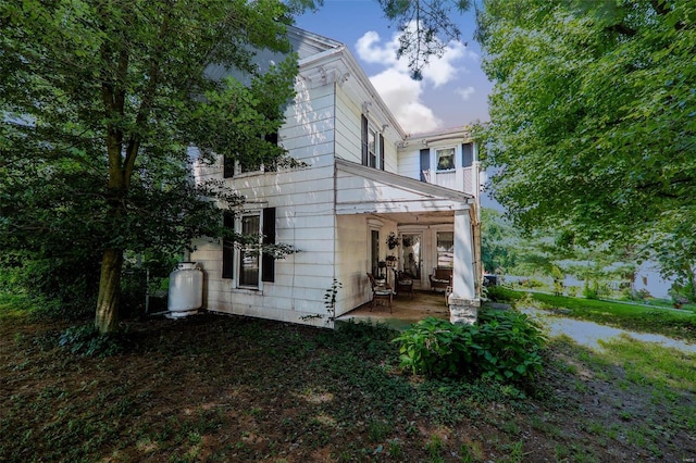 rear view of property featuring a patio area