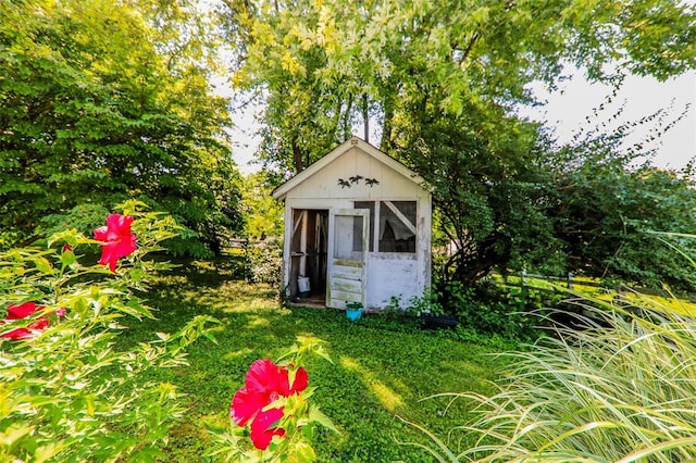 view of outbuilding with a yard