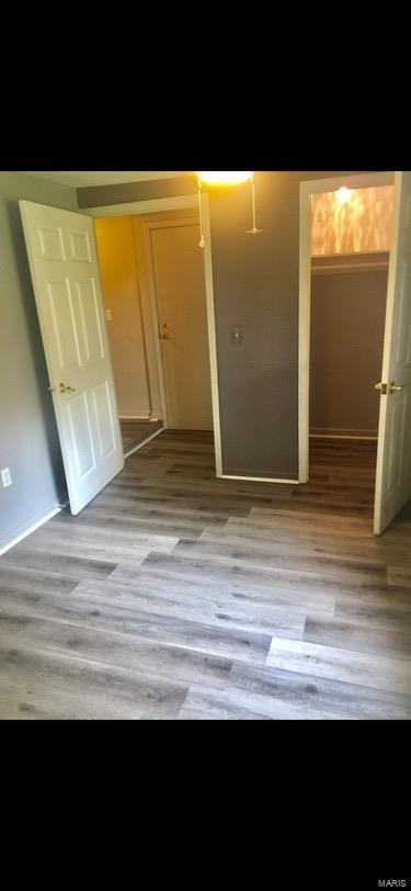 unfurnished bedroom with light hardwood / wood-style floors and a closet