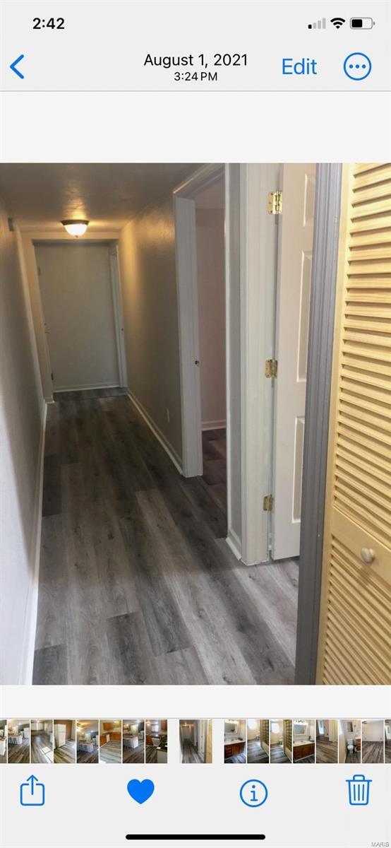 hallway with hardwood / wood-style floors