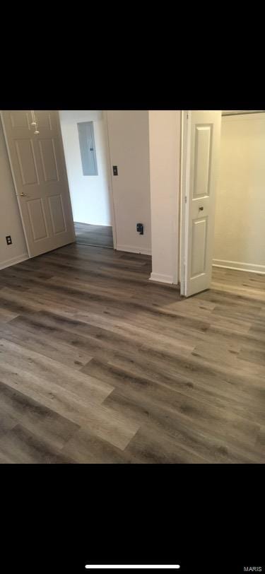 interior space featuring dark wood-type flooring and electric panel