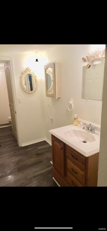 bathroom featuring vanity and hardwood / wood-style flooring