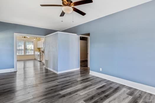 spare room featuring ceiling fan and dark hardwood / wood-style flooring