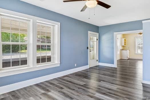 spare room featuring dark hardwood / wood-style floors and ceiling fan