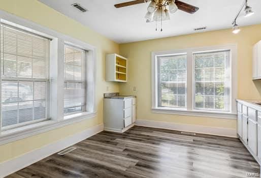 unfurnished dining area with dark wood-type flooring and ceiling fan