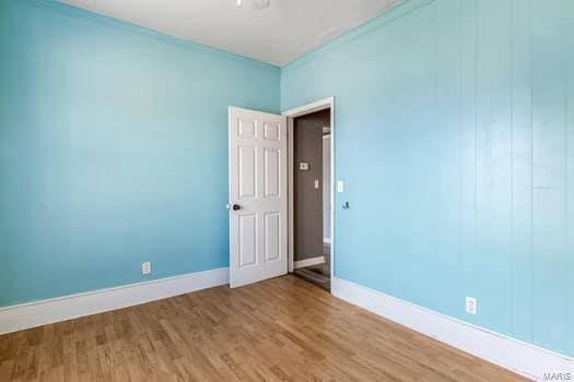 spare room with wood-type flooring