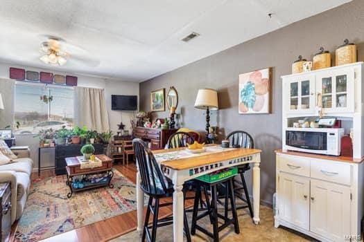 dining room featuring ceiling fan and light hardwood / wood-style flooring