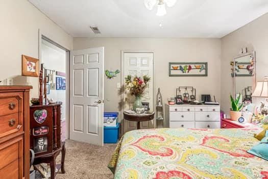 bedroom featuring light colored carpet and ceiling fan