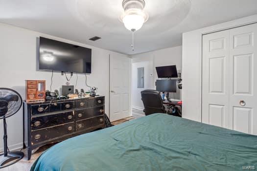 bedroom featuring a closet, ceiling fan, and electric panel