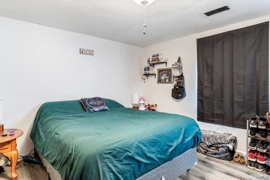 bedroom with hardwood / wood-style flooring