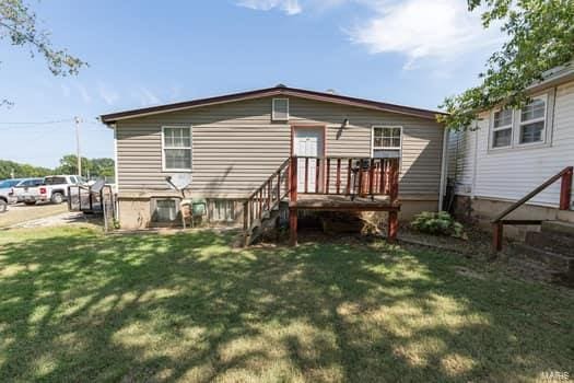 rear view of house with a lawn