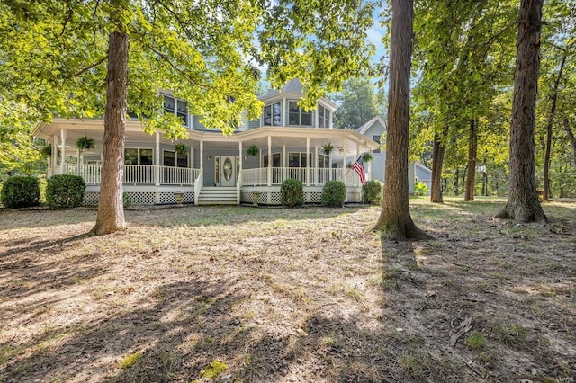 back of property with a porch