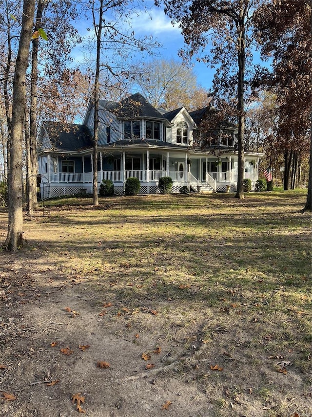 view of front of home featuring a porch and a front lawn