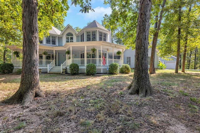 victorian house featuring a garage and covered porch