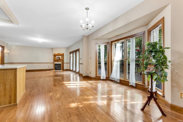 interior space featuring light hardwood / wood-style flooring and an inviting chandelier