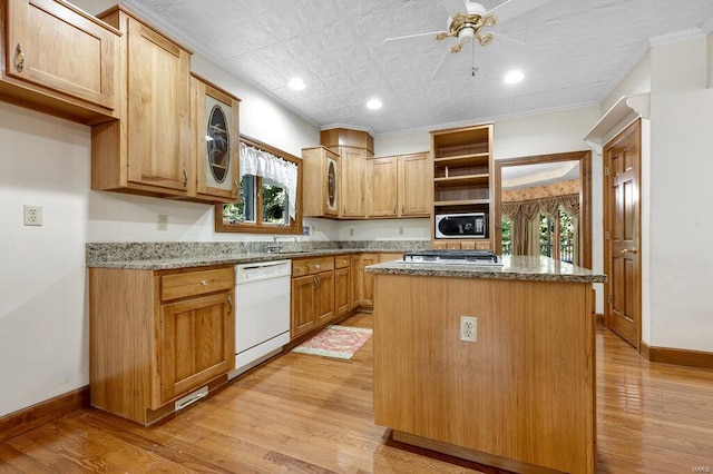 kitchen with white dishwasher, light hardwood / wood-style floors, and a center island