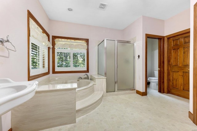 full bathroom featuring toilet, plus walk in shower, and sink